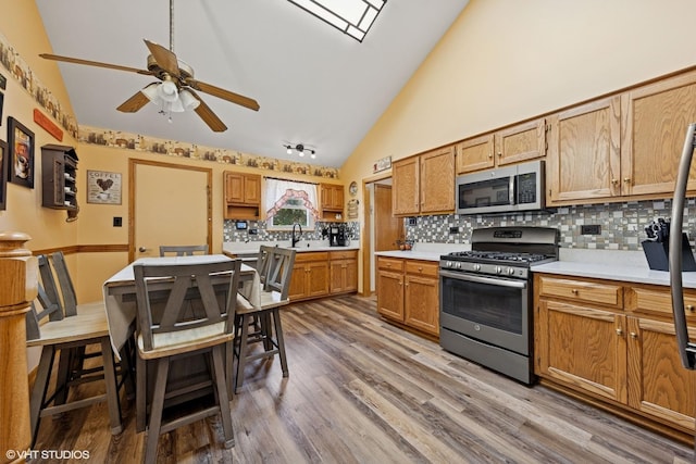 1908 Chestnut Hill Rd, Plainfield, IL 60586 - kitchen with stainless steel appliances, light countertops, backsplash, a ceiling fan, and wood finished floors