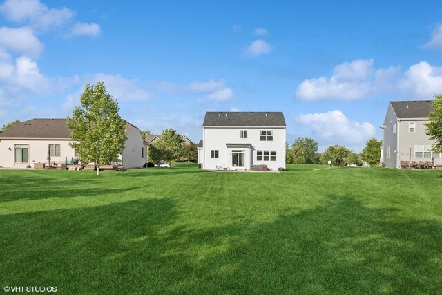 10831 Partridge Trl, Richmond, IL 60071 - back of property featuring a lawn and a patio area