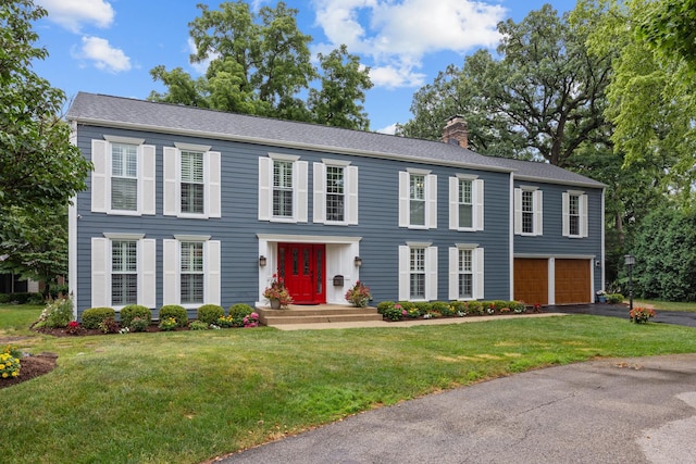 3 Old Valley Rd, Rolling Meadows, IL 60008 - colonial-style house with a chimney, a garage, driveway, and a front lawn