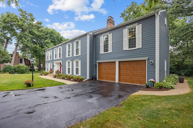 3 Old Valley Rd, Rolling Meadows, IL 60008 - view of front of property with a chimney, an attached garage, asphalt driveway, and a front lawn