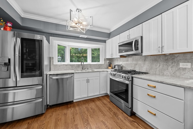 3 Old Valley Rd, Rolling Meadows, IL 60008 - kitchen featuring stainless steel appliances, a chandelier, tasteful backsplash, white cabinets, and crown molding