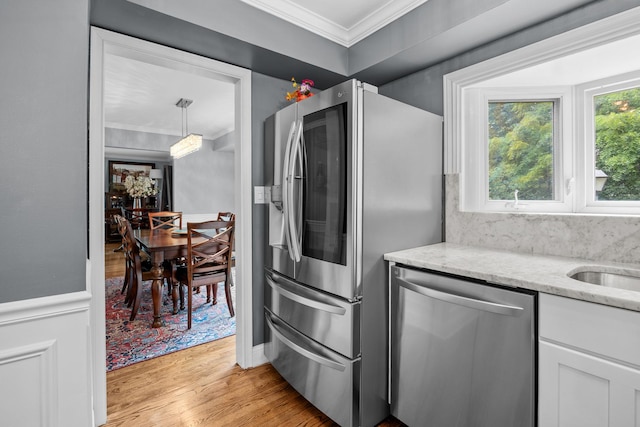 3 Old Valley Rd, Rolling Meadows, IL 60008 - kitchen featuring stainless steel appliances, ornamental molding, light wood-style flooring, light stone countertops, and white cabinetry