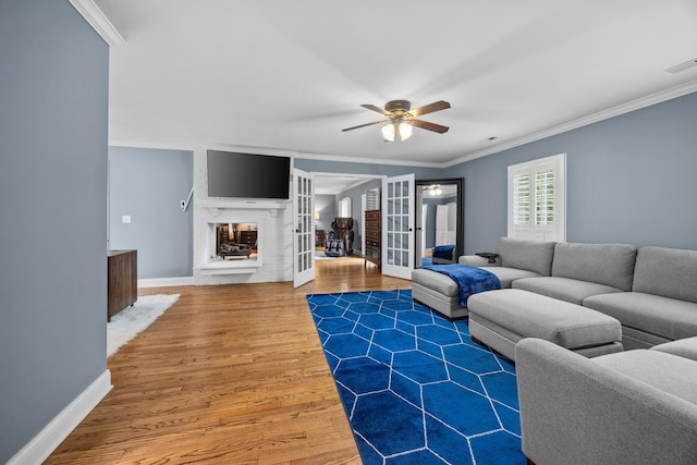 3 Old Valley Rd, Rolling Meadows, IL 60008 - living room featuring ornamental molding, wood finished floors, ceiling fan, french doors, and a multi sided fireplace