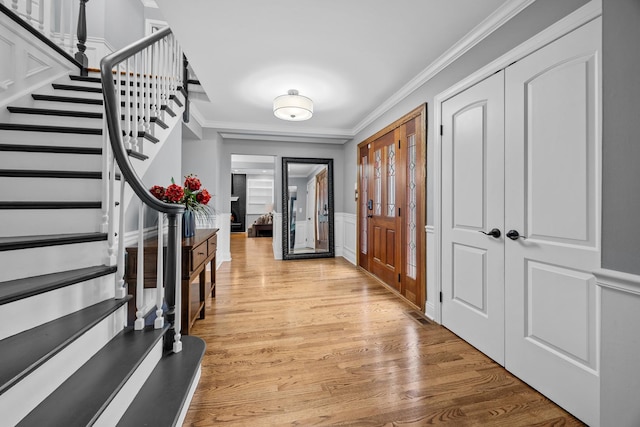 3 Old Valley Rd, Rolling Meadows, IL 60008 - foyer featuring ornamental molding, stairs, light wood-style floors, a wainscoted wall, and a decorative wall