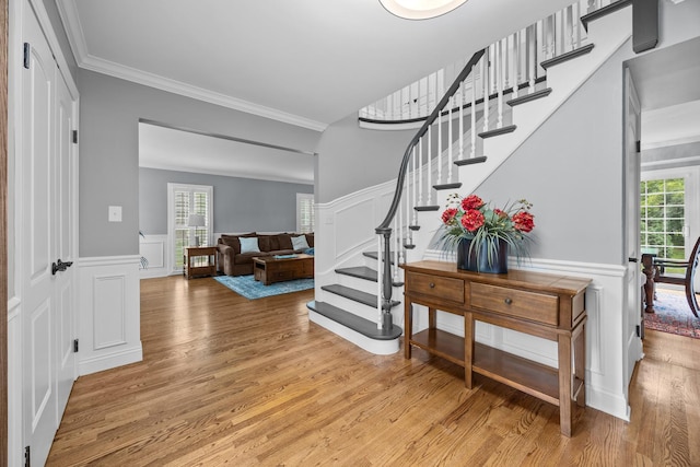 3 Old Valley Rd, Rolling Meadows, IL 60008 - foyer entrance featuring a decorative wall, wainscoting, crown molding, light wood-type flooring, and plenty of natural light