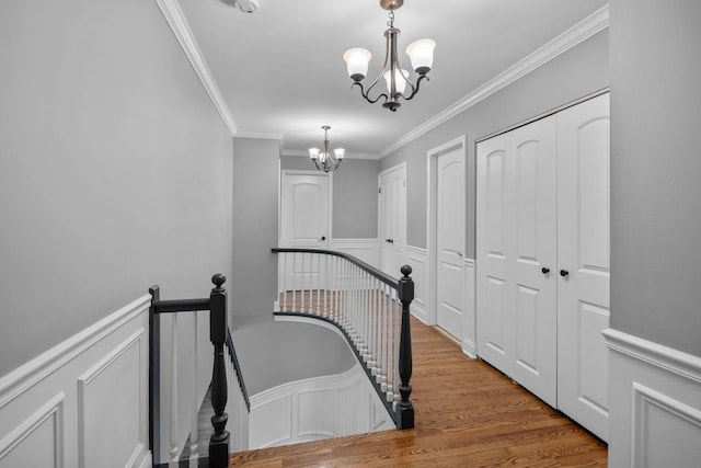 3 Old Valley Rd, Rolling Meadows, IL 60008 - corridor with an upstairs landing, a chandelier, a decorative wall, crown molding, and wainscoting