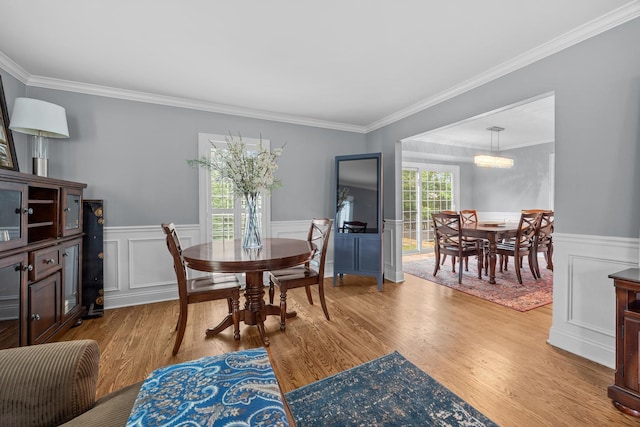 3 Old Valley Rd, Rolling Meadows, IL 60008 - dining area with light wood-type flooring, a wainscoted wall, crown molding, and a decorative wall