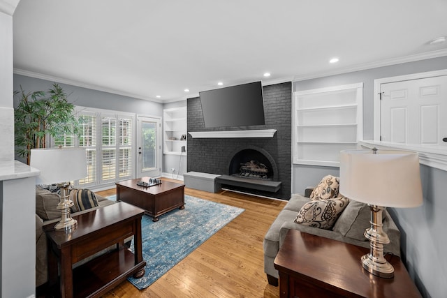 3 Old Valley Rd, Rolling Meadows, IL 60008 - living room featuring built in shelves, recessed lighting, ornamental molding, a fireplace, and light wood-style floors