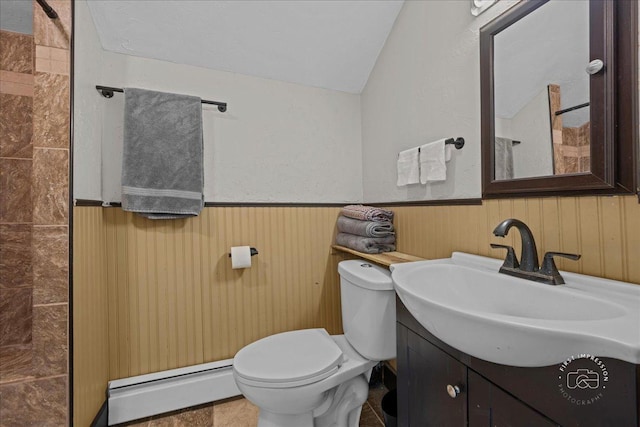 32W167 Army Trail Rd, Wayne, IL 60184 - bathroom with baseboard heating, tiled shower, vanity, vaulted ceiling, and wainscoting