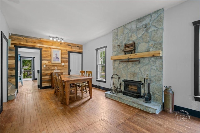 32W167 Army Trail Rd, Wayne, IL 60184 - dining area featuring wood walls, wood-type flooring, an accent wall, and rail lighting