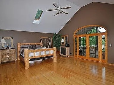 9417 W Steger Rd, Frankfort, IL 60423 - bedroom featuring a skylight, wood finished floors, and high vaulted ceiling
