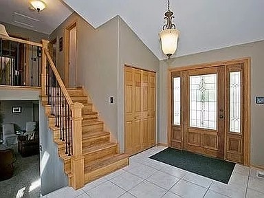 9417 W Steger Rd, Frankfort, IL 60423 - entrance foyer with stairway, tile patterned floors, and vaulted ceiling