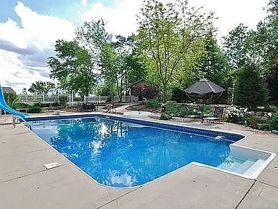 9417 W Steger Rd, Frankfort, IL 60423 - view of swimming pool with a patio, a water slide, and a diving board