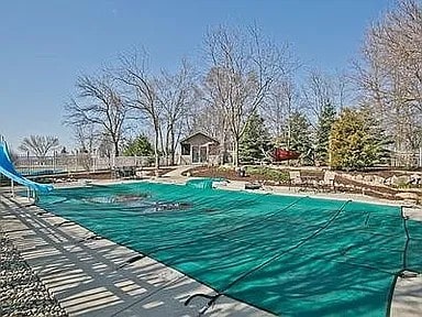 9417 W Steger Rd, Frankfort, IL 60423 - view of pool featuring a water slide, a patio area, and a covered pool