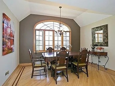 9417 W Steger Rd, Frankfort, IL 60423 - dining room featuring light wood-style flooring, healthy amount of natural light, lofted ceiling, and a chandelier