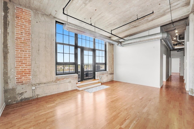 3963 W Belmont Ave Unit 613, Chicago, IL 60618 - unfurnished living room featuring wood finished floors and a high ceiling