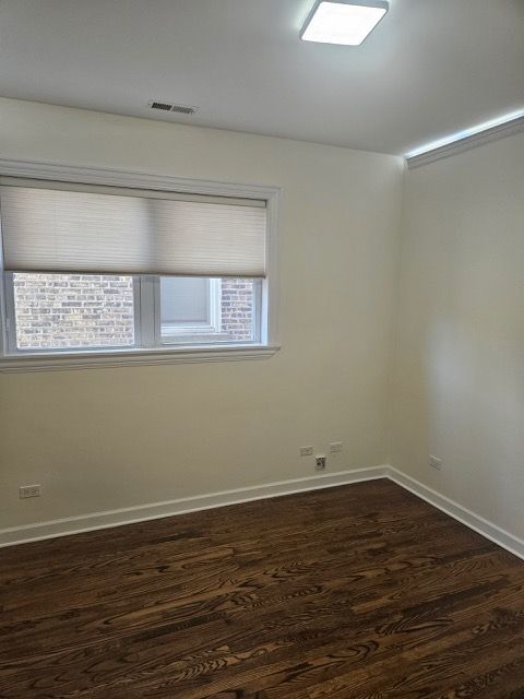 2447 W Walton St Unit 2, Chicago, IL 60622 - empty room featuring dark wood-type flooring