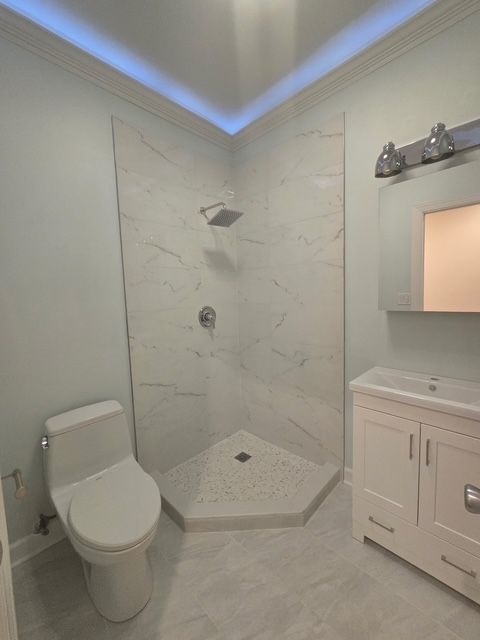 2447 W Walton St Unit 2, Chicago, IL 60622 - full bath with ornamental molding, a marble finish shower, and vanity