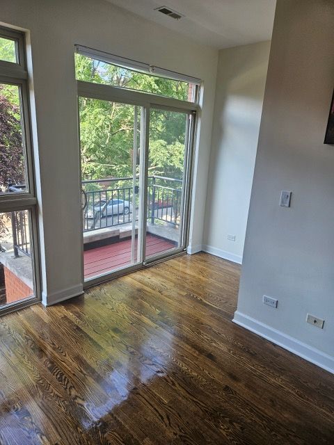 2447 W Walton St Unit 2, Chicago, IL 60622 - empty room with baseboards and wood finished floors