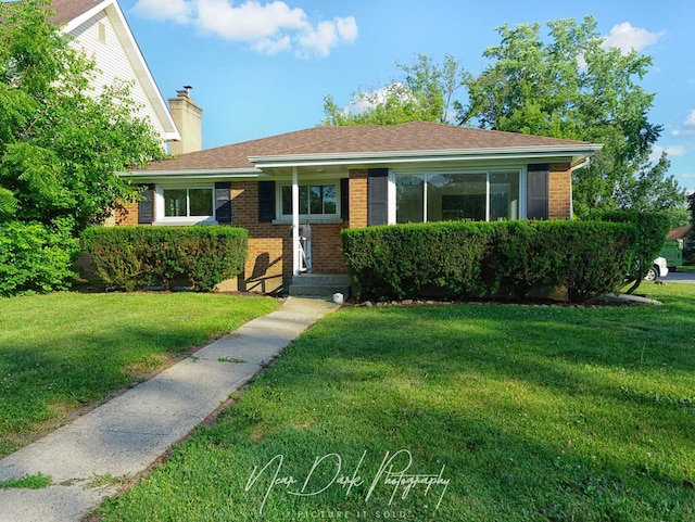 837 Wilcox Ave, Mundelein, IL 60060 - single story home with brick siding, a front yard, and a chimney