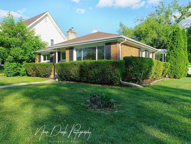 837 Wilcox Ave, Mundelein, IL 60060 - view of front facade with brick siding, a chimney, and a front yard