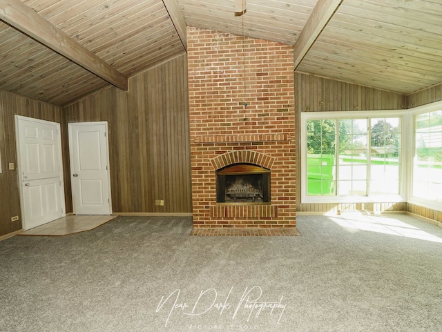 837 Wilcox Ave, Mundelein, IL 60060 - unfurnished living room with lofted ceiling, wooden walls, carpet floors, and a brick fireplace