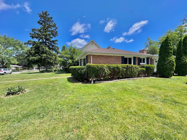 837 Wilcox Ave, Mundelein, IL 60060 - view of side of home featuring brick siding, a lawn, and a chimney