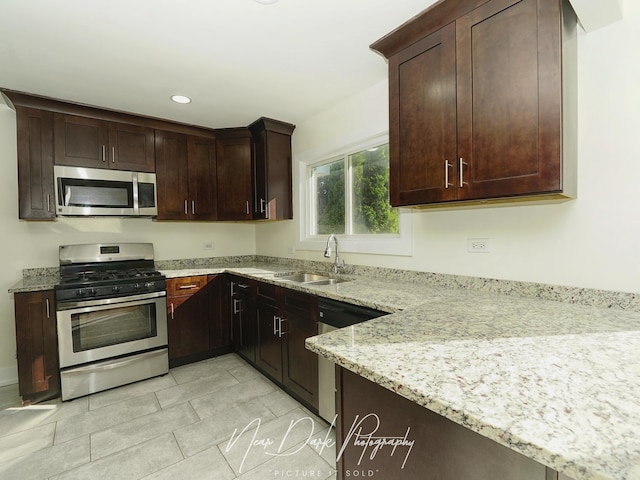 837 Wilcox Ave, Mundelein, IL 60060 - kitchen featuring appliances with stainless steel finishes, light stone countertops, recessed lighting, light tile patterned flooring, and dark brown cabinets