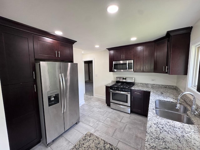 837 Wilcox Ave, Mundelein, IL 60060 - kitchen with stainless steel appliances, recessed lighting, light stone counters, dark brown cabinets, and light tile patterned flooring