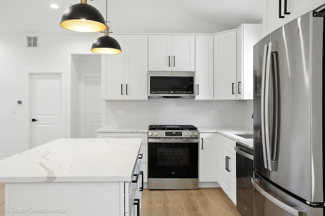 8100 Lockwood Ave, Burbank, IL 60459 - kitchen with appliances with stainless steel finishes, light wood-style flooring, backsplash, white cabinets, and a center island