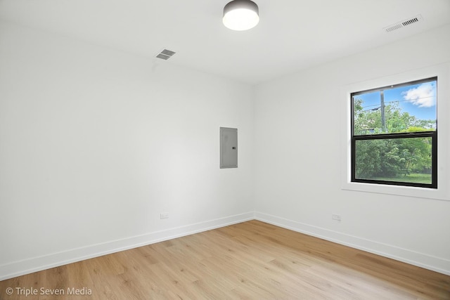 8100 Lockwood Ave, Burbank, IL 60459 - empty room with electric panel and light wood finished floors