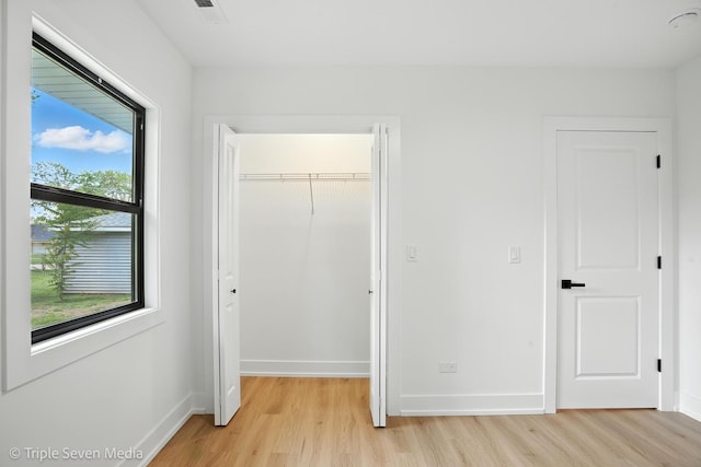 8100 Lockwood Ave, Burbank, IL 60459 - unfurnished bedroom with light wood-type flooring and a closet