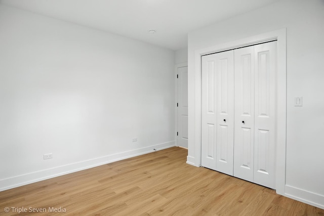 8100 Lockwood Ave, Burbank, IL 60459 - unfurnished bedroom with light wood-style floors and a closet