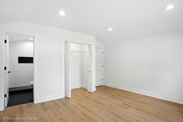 8100 Lockwood Ave, Burbank, IL 60459 - unfurnished bedroom featuring lofted ceiling, light wood-style floors, recessed lighting, ensuite bath, and a closet