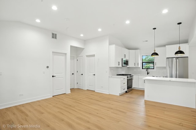 8100 Lockwood Ave, Burbank, IL 60459 - kitchen featuring appliances with stainless steel finishes, vaulted ceiling, light countertops, light wood-type flooring, and recessed lighting