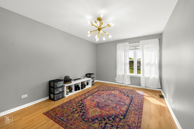 417 Chadsford Ct, Carol Stream, IL 60188 - spare room featuring a chandelier and wood finished floors