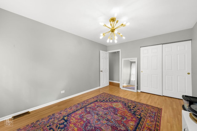 417 Chadsford Ct, Carol Stream, IL 60188 - unfurnished bedroom featuring a chandelier, wood finished floors, and a closet