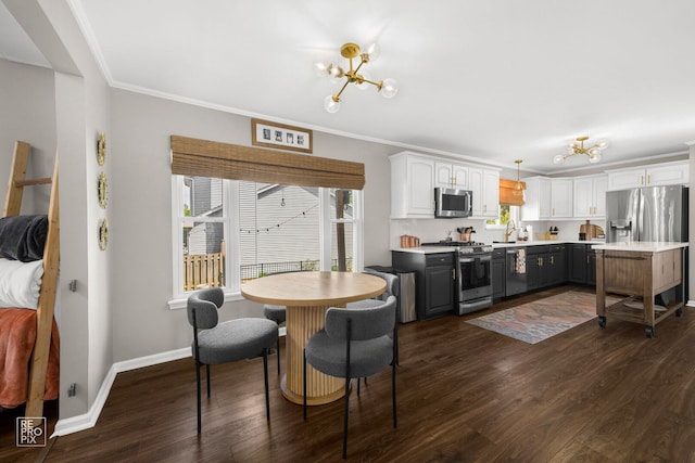 417 Chadsford Ct, Carol Stream, IL 60188 - dining area featuring dark wood-style floors, plenty of natural light, a chandelier, and crown molding