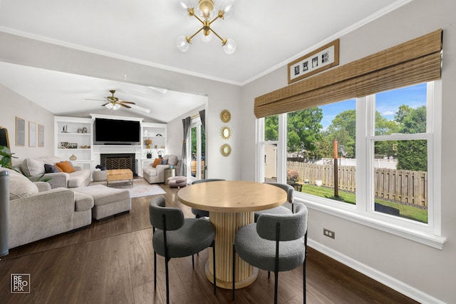 417 Chadsford Ct, Carol Stream, IL 60188 - dining space with healthy amount of natural light, dark wood finished floors, a fireplace, ceiling fan, and crown molding