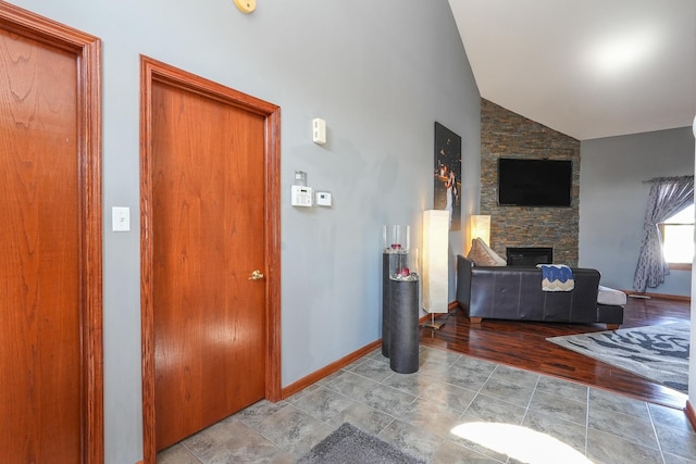 2069 Willow Brook Dr, Bourbonnais, IL 60914 - entryway with a stone fireplace, wood finished floors, and high vaulted ceiling