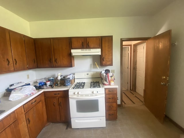 217-219 Mulvain St, Durand, IL 61024 - kitchen with under cabinet range hood, white range with gas stovetop, and light countertops