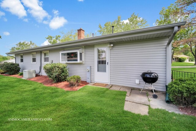 1607 Warwick Ln, Schaumburg, IL 60193 - rear view of house featuring a lawn and a chimney