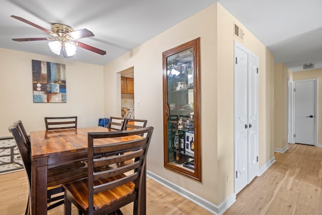 7100 W 95th St Unit 110, Oak Lawn, IL 60453 - dining room featuring ceiling fan and light wood-style flooring