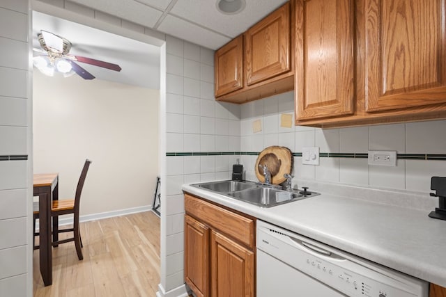 7100 W 95th St Unit 110, Oak Lawn, IL 60453 - kitchen featuring dishwasher, light wood-type flooring, brown cabinets, and decorative backsplash