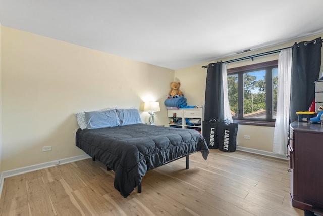 7100 W 95th St Unit 110, Oak Lawn, IL 60453 - bedroom with baseboards and light wood-type flooring
