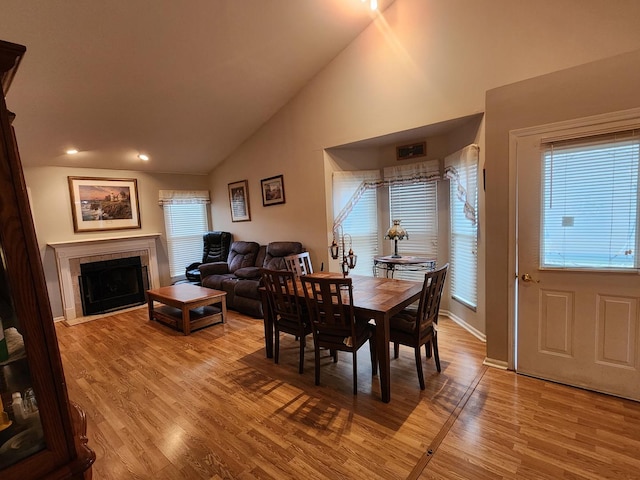 1036 Georgian Pl, Bartlett, IL 60103 - dining space featuring plenty of natural light, light wood-style floors, a fireplace, high vaulted ceiling, and recessed lighting