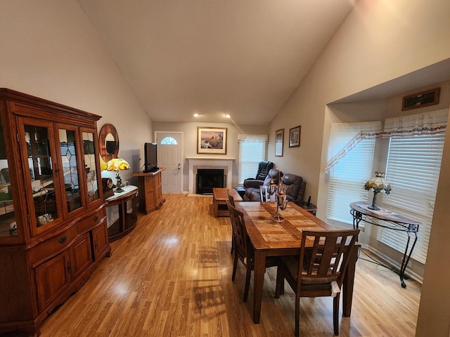 1036 Georgian Pl, Bartlett, IL 60103 - dining space with light wood-type flooring, a fireplace, high vaulted ceiling, and recessed lighting