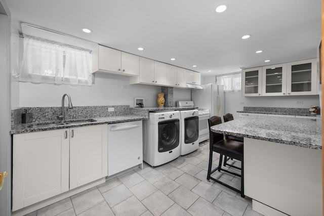 4316 N Sayre Ave, Norridge, IL 60706 - kitchen with white appliances, washing machine and dryer, recessed lighting, white cabinets, and glass insert cabinets