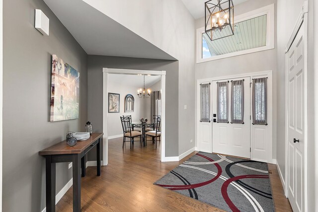 16243 Hummingbird Hill Dr, Orland Park, IL 60467 - entryway with a chandelier, dark wood-type flooring, and a towering ceiling
