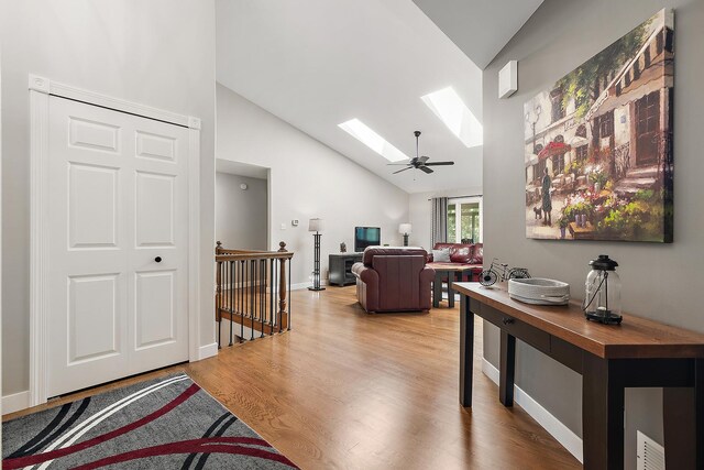16243 Hummingbird Hill Dr, Orland Park, IL 60467 - living area with a skylight, light wood-style flooring, and high vaulted ceiling